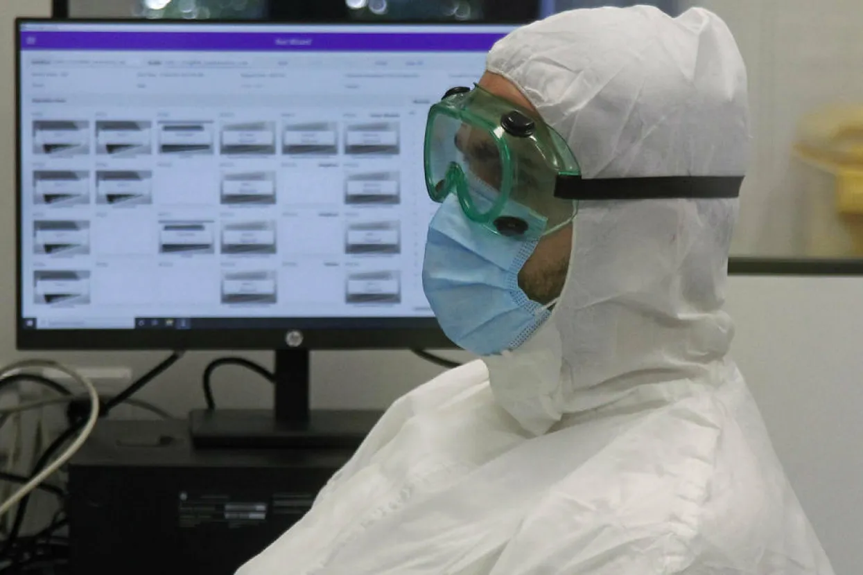 epa08574218 A person works on polymerase chain reaction (PCR) testing samples for coronavirus detection in the Fire Eye laboratory in Nis, Serbia, 30 July 2020. The laboratory was a donation from the Chinese Government and will be able to process approximately 1,000 samples a day. The laboratory was officially opened on 30 July and is the second of its kind in Serbia. EPA-EFE/Djordje Savic