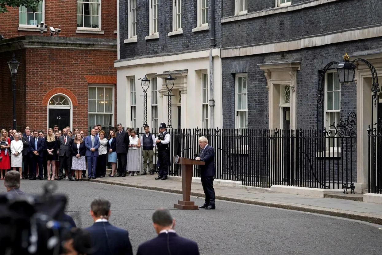 Prime Minister Boris Johnson, watched by wife Carrie Johnson (centre holding daughter Romy), reads a statement outside 10 Downing Street, London, formally resigning as Conservative Party leader after ministers and MPs made clear his position was untenable. He will remain as Prime Minister until a successor is in place. Picture date: Thursday July 7, 2022. Photo: Gareth Fuller/PRESS ASSOCIATION