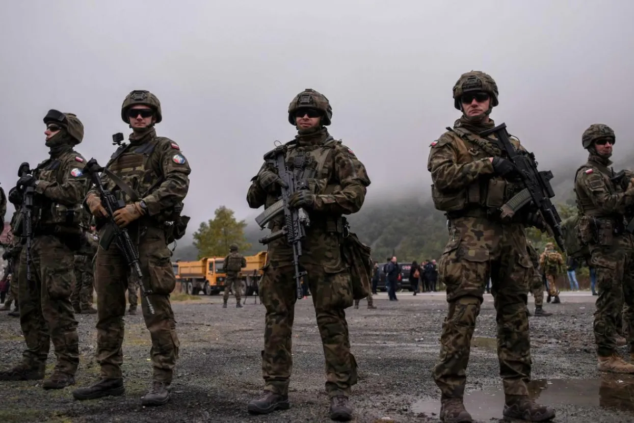 Polish soldiers part of NATO-led international peacekeeping force in Kosovo KFOR next to a road barricade set up by ethnic Serbs near the town of Zubin Potok, on 1 August 2022